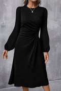 Black dress with long sleeves on a gray background