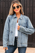 Woman wearing a denim jacket and sunglasses against a dark background